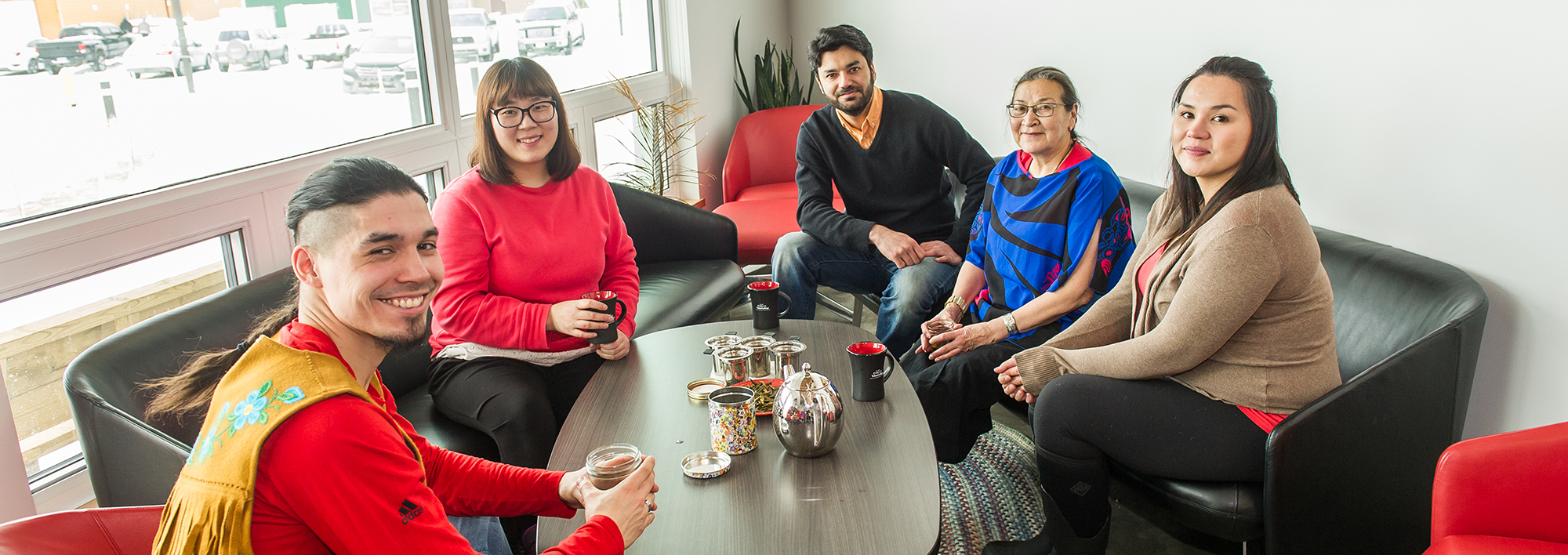 Students having tea with an Elder on Campus