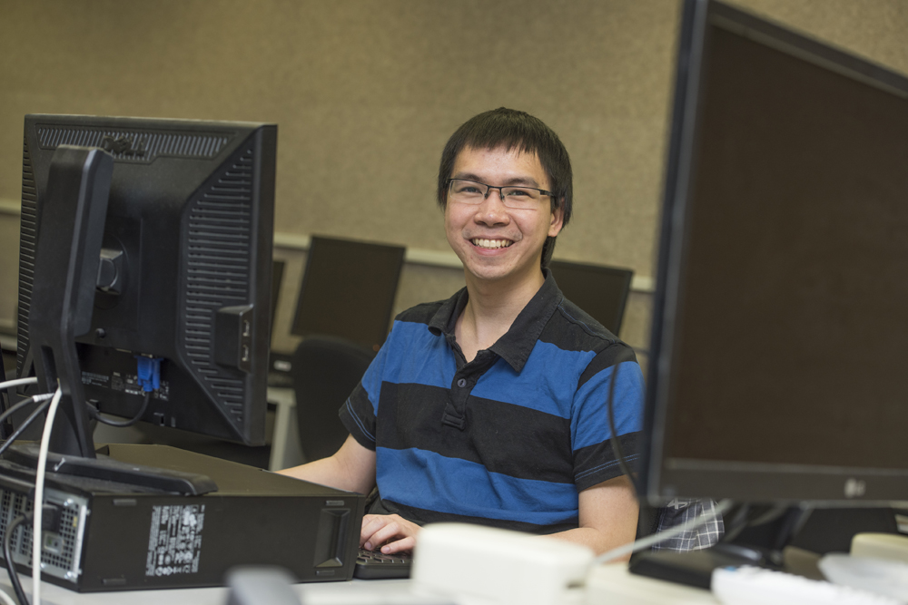 student behind a PC computer