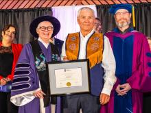 Stanley Njootli receiving a framed degree parchment from Dr. Lesley Brown and Dr. Ernie Prokopchuk